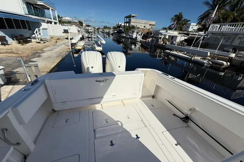  Yacht Photos Pics 2014 Intrepid 327 Center Console boat docked in a residential canal.