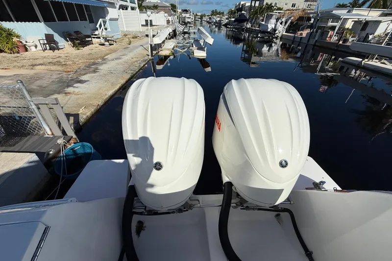  Yacht Photos Pics 2014 Intrepid 327 Center Console with twin Yamaha outboard engines docked by a canal.