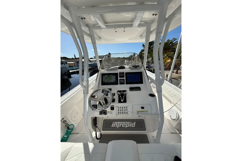  Yacht Photos Pics 2014 Intrepid 327 Center Console boat cockpit with steering wheel and navigation screens.