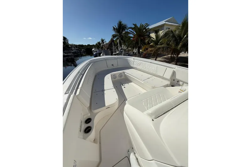  Yacht Photos Pics 2014 Intrepid 327 Center Console boat with spacious seating, docked near palm trees.
