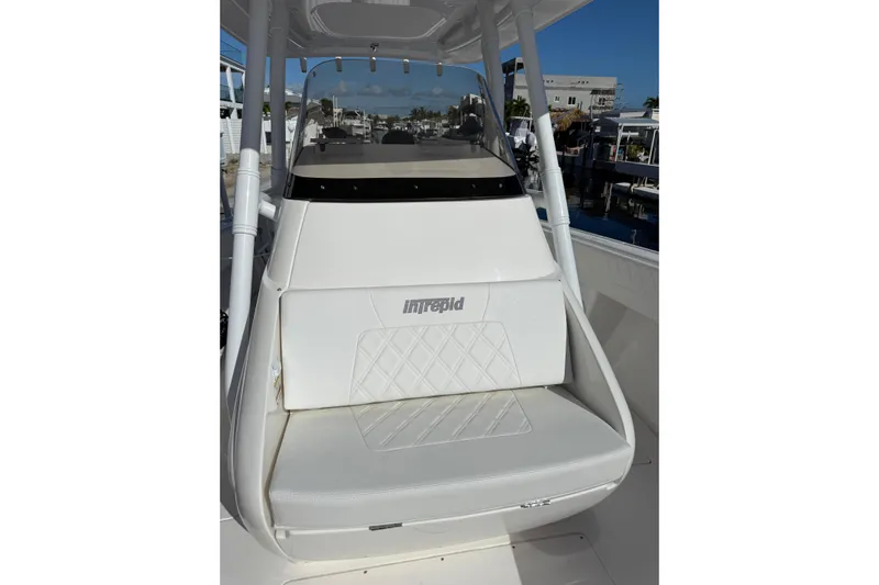  Yacht Photos Pics 2014 Intrepid 327 Center Console boat with white seating and console, docked at marina.