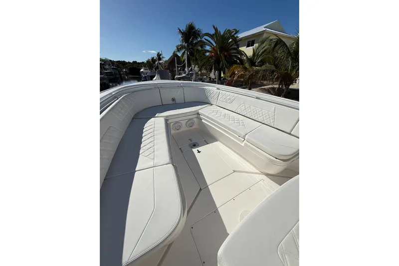  Yacht Photos Pics 2014 Intrepid 327 Center Console boat with white seating and tropical background.