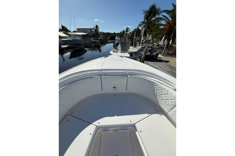  Yacht Photos Pics 2014 Intrepid 327 Center Console boat docked near palm trees and waterfront homes.
