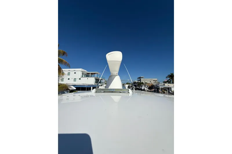  Yacht Photos Pics 2014 Intrepid 327 Center Console boat with radar, docked near waterfront homes.