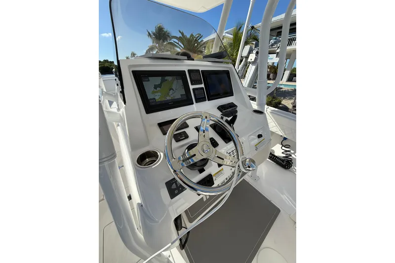  Yacht Photos Pics 2014 Intrepid 327 Center Console boat dashboard with steering wheel and navigation screens.