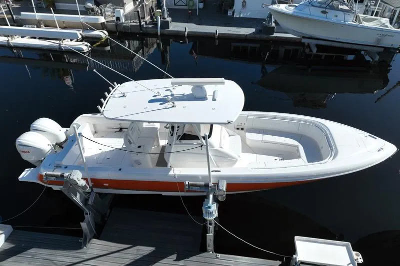  Yacht Photos Pics 2014 Intrepid 327 Center Console boat docked, featuring sleek design and dual engines.