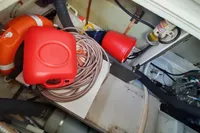 Engine compartment of a 2015 Sas-Vektor 950 with safety equipment and wiring.