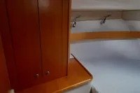 Cozy cabin interior of 2015 Sas-Vektor 950 yacht with wooden cabinetry and bed.