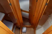 Interior of 2015 Sas-Vektor 950 boat with wooden finish and compact design.