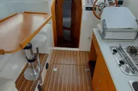 Interior of 2015 Sas-Vektor 950 boat with wooden flooring and modern amenities.
