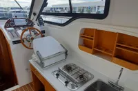 Interior of 2015 Sas-Vektor 950 boat with kitchen and steering area.