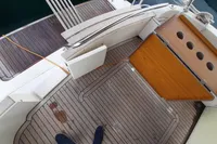 Deck view of a 2015 Sas-Vektor 950 boat with wooden flooring and storage compartments.