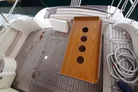 Sas-Vektor 950 boat deck, 2015 model, featuring wooden table and coiled rope.