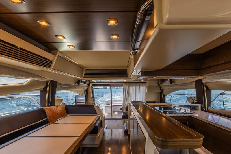 Prime Time II Yacht Photos Pics Luxurious interior of 2016 Azimut 64 Flybridge yacht with elegant dining and seating area.