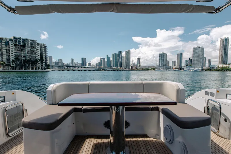 Prime Time II Yacht Photos Pics Azimut 64 Flybridge 2016 yacht with city skyline view, featuring outdoor seating and table.
