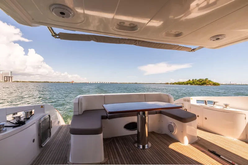 Prime Time II Yacht Photos Pics 2016 Azimut 64 Flybridge yacht deck with seating, table, and ocean view.