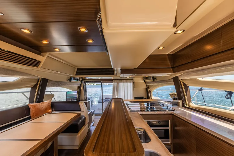 Prime Time II Yacht Photos Pics Luxurious interior of 2016 Azimut 64 Flybridge yacht with modern design and wood accents.