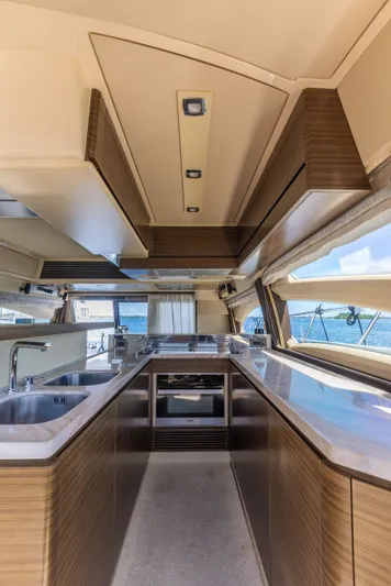 Prime Time II Yacht Photos Pics Luxurious interior of a 2016 Azimut 64 Flybridge yacht kitchen with modern amenities.