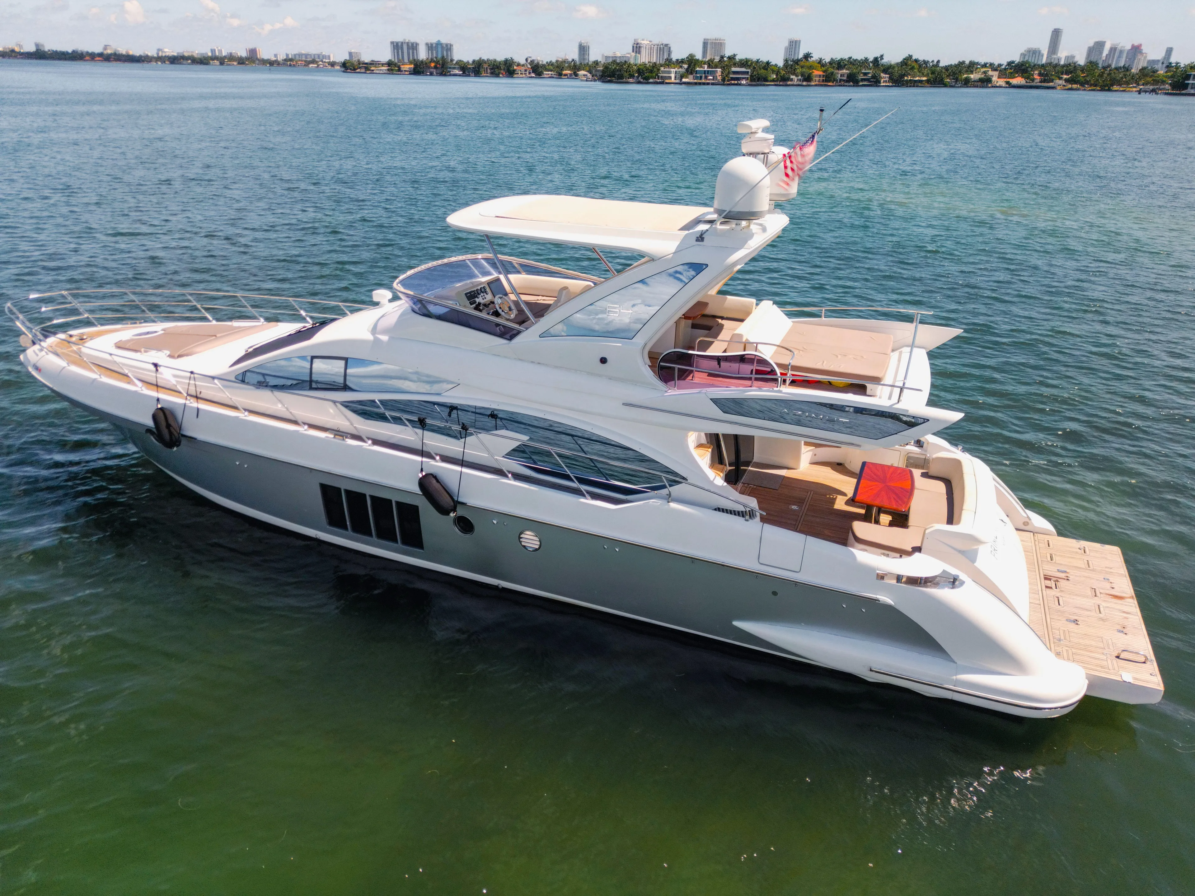 Prime Time II Yacht Photos Pics Luxurious 2016 Azimut 64 Flybridge yacht cruising on serene waters.