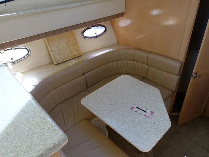  Yacht Photos Pics Interior of 2000 Carver 406 Aft Cabin Motor Yacht with beige seating and table.