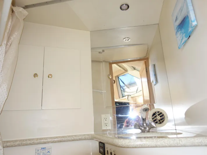  Yacht Photos Pics Interior of 2000 Carver 406 Aft Cabin Motor Yacht bathroom with sink and mirror.