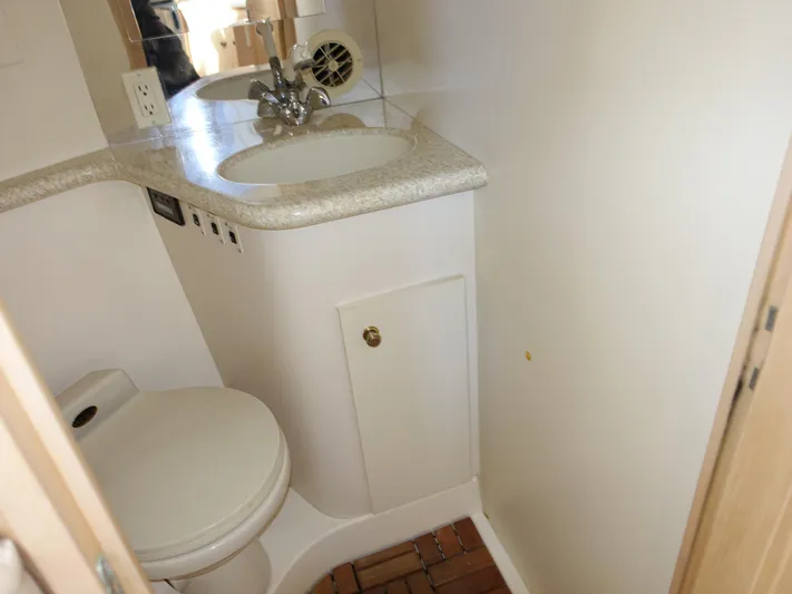  Yacht Photos Pics Compact bathroom in 2000 Carver 406 Aft Cabin Motor Yacht with sink and toilet.