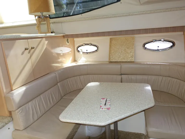 Yacht Photos Pics 2000 Carver 406 Aft Cabin Motor Yacht interior with beige seating and table.
