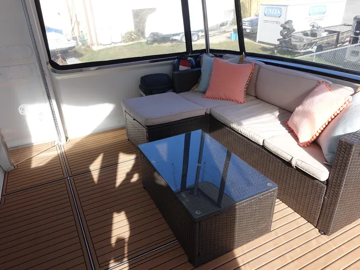  Yacht Photos Pics 2000 Carver 406 Aft Cabin Motor Yacht interior with wicker seating and glass table.