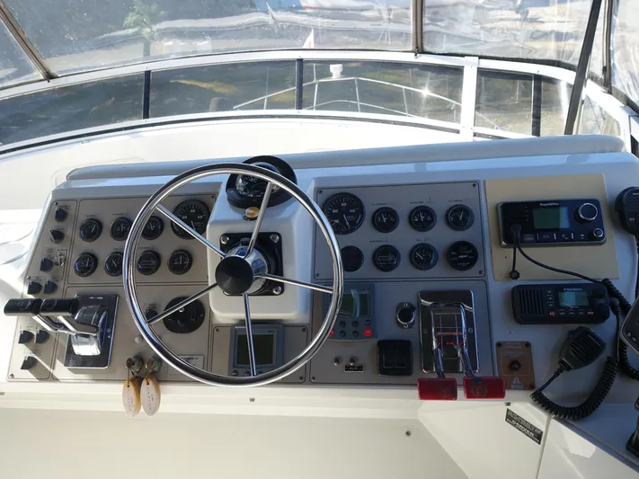  Yacht Photos Pics Control panel of 2000 Carver 406 Aft Cabin Motor Yacht with steering wheel and gauges.