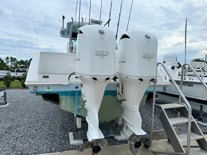  Yacht Photos Pics 2008 Everglades 320CC boat with twin Yamaha 350 engines, docked on gravel.