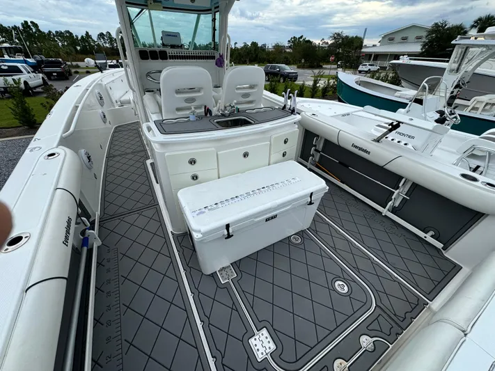  Yacht Photos Pics 2008 Everglades 320CC boat interior with seating and storage, docked outdoors.