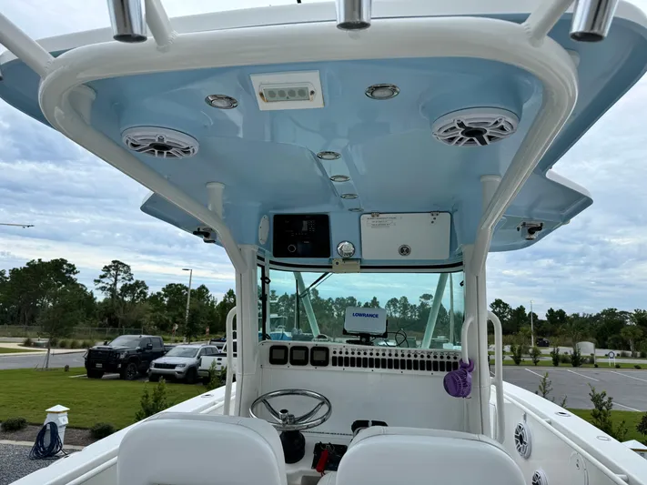  Yacht Photos Pics 2008 Everglades 320CC boat interior with blue canopy and steering console.