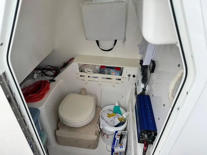  Yacht Photos Pics Interior of 2008 Everglades 320CC boat with toilet and storage area.