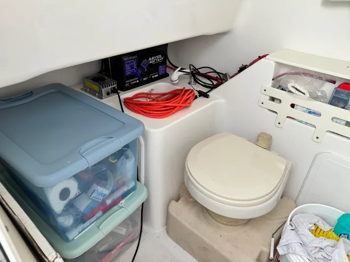  Yacht Photos Pics 2008 Everglades 320CC boat interior with storage, toilet, and equipment.