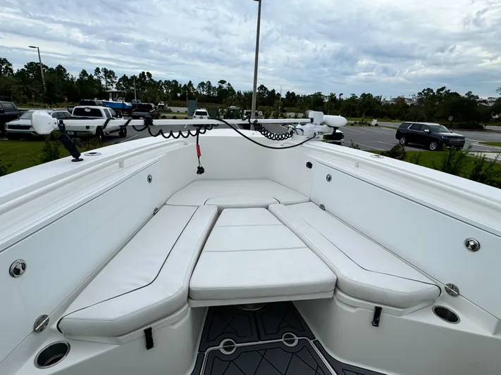  Yacht Photos Pics 2008 Everglades 320CC boat interior with white cushioned seating and fishing equipment.