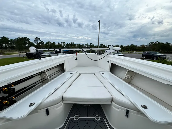  Yacht Photos Pics 2008 Everglades 320CC boat interior with seating and storage, under a cloudy sky.