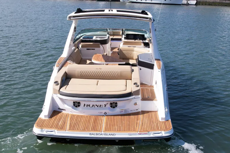 Honey Yacht Photos Pics 2019 Sea Ray SLX 310 boat with spacious seating, teak flooring, and sleek design on the water.