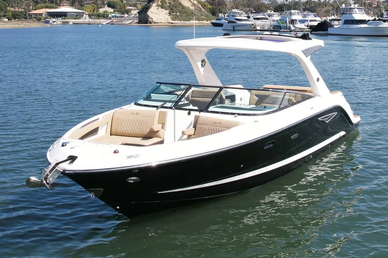 Honey Yacht Photos Pics 2019 Sea Ray SLX 310 boat on calm water, featuring sleek design and spacious seating.