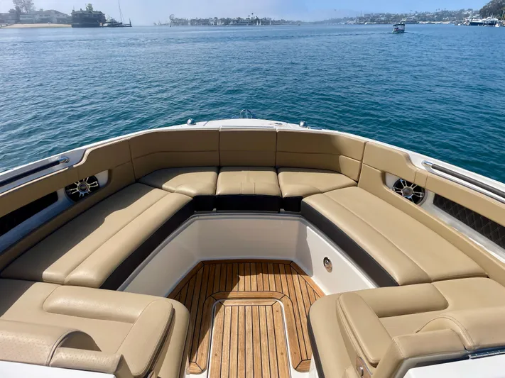 Honey Yacht Photos Pics 2019 Sea Ray SLX 310 boat with tan seating and wooden deck on calm water.