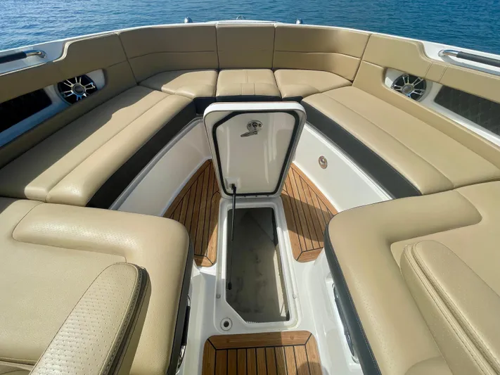 Honey Yacht Photos Pics Luxurious 2019 Sea Ray SLX 310 boat interior with tan seating and teak flooring.