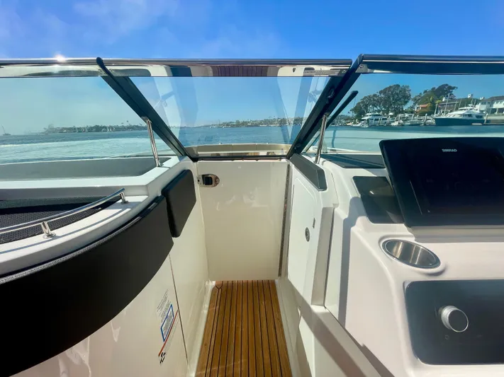 Honey Yacht Photos Pics 2019 Sea Ray SLX 310 boat interior with wooden flooring and clear view of the water.