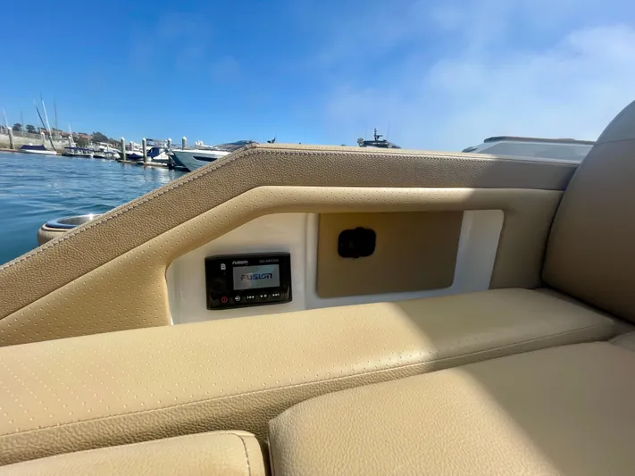 Honey Yacht Photos Pics 2019 Sea Ray SLX 310 boat interior with beige seating and control panel, docked at marina.