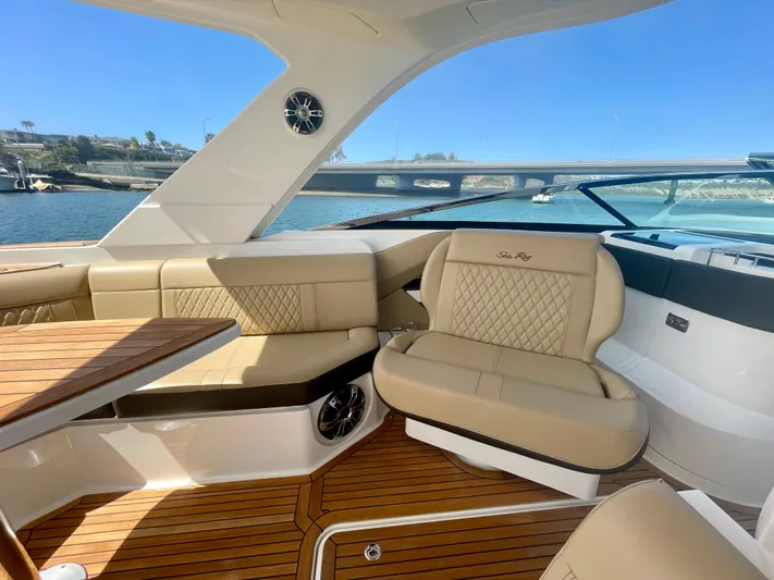 Honey Yacht Photos Pics Luxurious interior of 2019 Sea Ray SLX 310 boat with beige seating and wooden flooring.