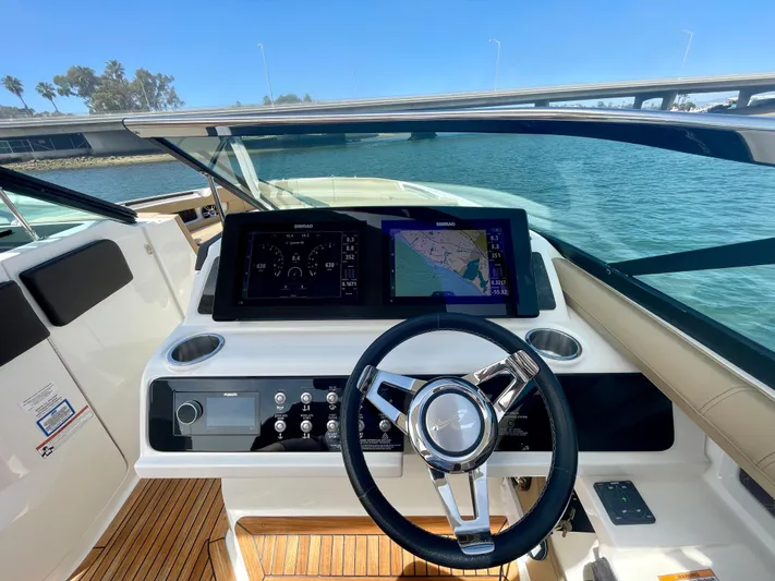 Honey Yacht Photos Pics 2019 Sea Ray SLX 310 helm with modern navigation display and steering wheel on open water.