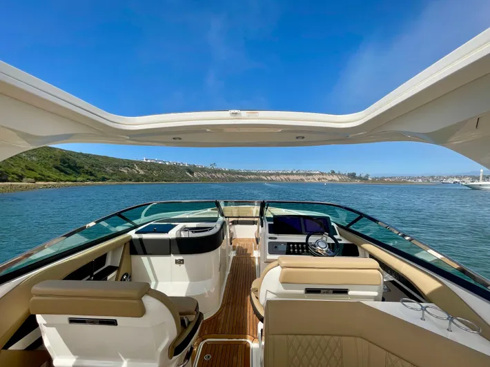 Honey Yacht Photos Pics 2019 Sea Ray SLX 310 boat interior with open deck, luxurious seating, and scenic water view.