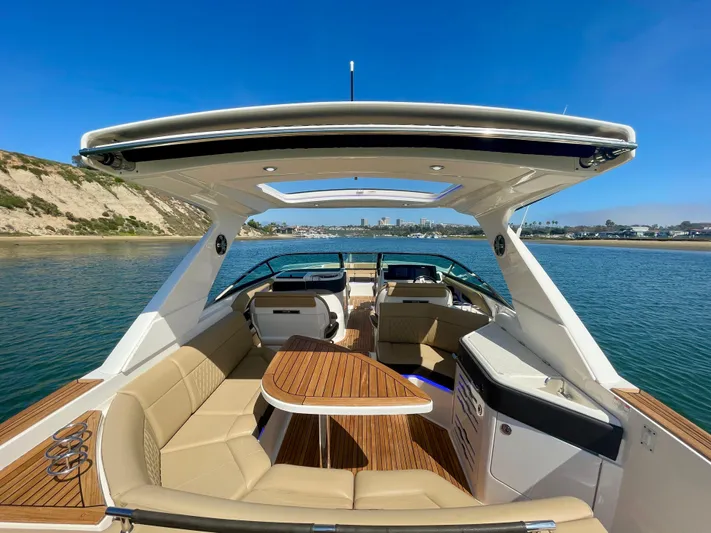Honey Yacht Photos Pics 2019 Sea Ray SLX 310 boat with spacious seating and elegant design on calm water.