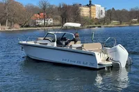 Nimbus T8 2020 boat cruising on a calm lake with scenic background.