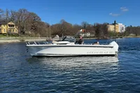 2020 Nimbus T8 boat on a calm lake with scenic background.