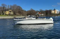 2020 Nimbus T8 boat cruising on a calm lake with scenic background.