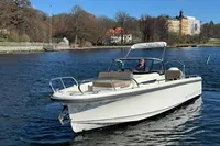 2020 Nimbus T8 boat cruising on a calm river with scenic background.